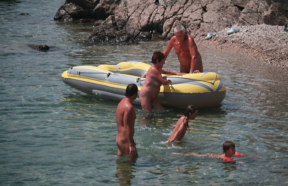 Lone Nudist in Yellow Boat photos - The Pursuit of Naturalness, Freedom, and Body Acceptance
