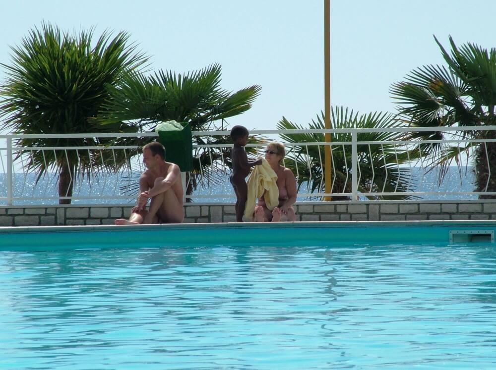 Photo of naturists in an outdoor pool - Nudity helps overcome insecurities and fears