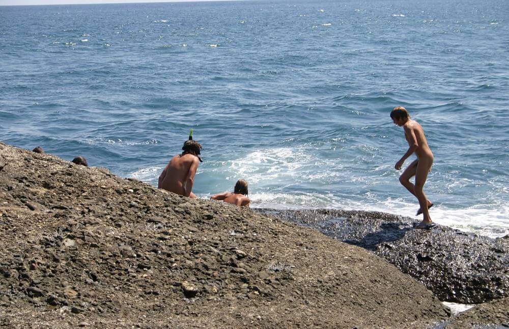 Leaning Against Hit Rocks pics - Nudism and natural harmony